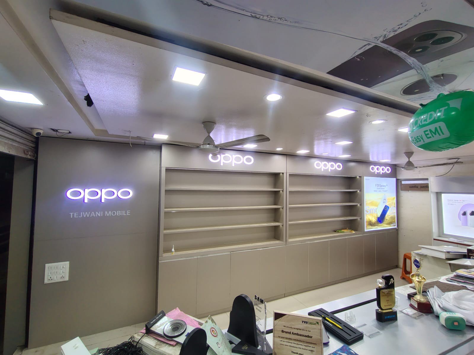 After — complete OPPO in-shop branding with backlit signage, wall panels and display shelving, Tejwani Mobile, Amravati